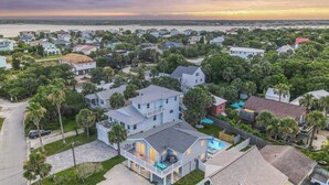 A residential area with houses, a swimming pool, and a view of the water. - Walk to Vilano Beach + Pool + Hot Tub + Pets (St. Augustine)