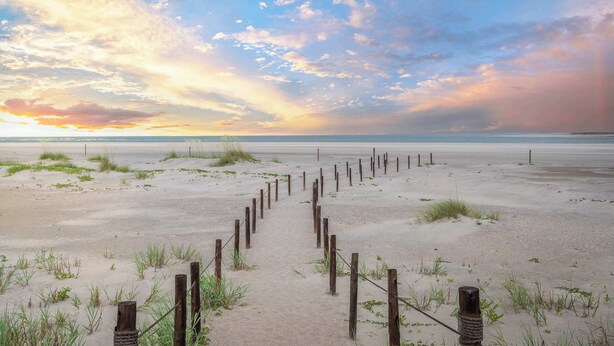 A sandy beach with a wooden fence leading to the water. - Walk to Vilano Beach + Pool + Hot Tub + Pets (St. Augustine)