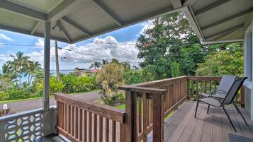 Relax in a serene garden setting with a deck and lush greenery.
