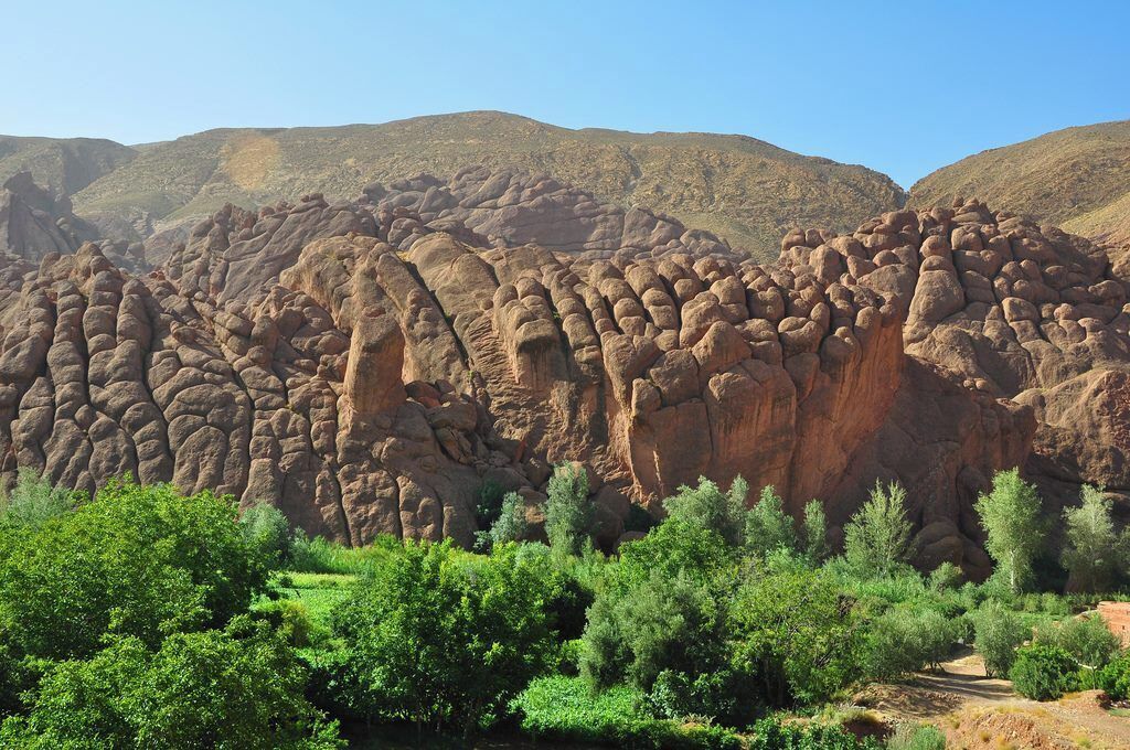 A natural landscape with rock formations and green vegetation.