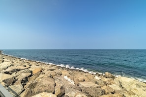 A rocky shoreline with waves crashing against the rocks.