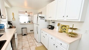 A modern kitchen with white cabinets, a built-in oven, and a window above the sink. - 3 Bedroom 2 Bath Home Close to ND w Fire pit 1155 (South Bend)