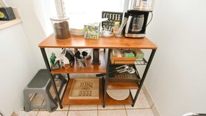A kitchen counter with a coffee maker, a jar, a box, and a sign that says "COFFEE keeps me going." - 3 Bedroom 2 Bath Home Close to ND w Fire pit 1155 (South Bend)