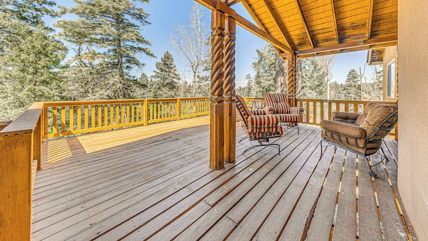 A wooden deck with a railing, two chairs, and a view of trees. - 2 Mi to Dtwn: Cloudcroft Home w/ Furnished Deck (Cloudcroft)