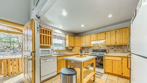 A kitchen with wooden cabinets, a white countertop, and a stainless steel trash can. - 2 Mi to Dtwn: Cloudcroft Home w/ Furnished Deck (Cloudcroft)