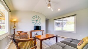 A living room with a sofa, chairs, a coffee table, a clock, and a television. - 3 Mi to Caesars Casino: Indiana Retreat w/ Patio! (New Albany)