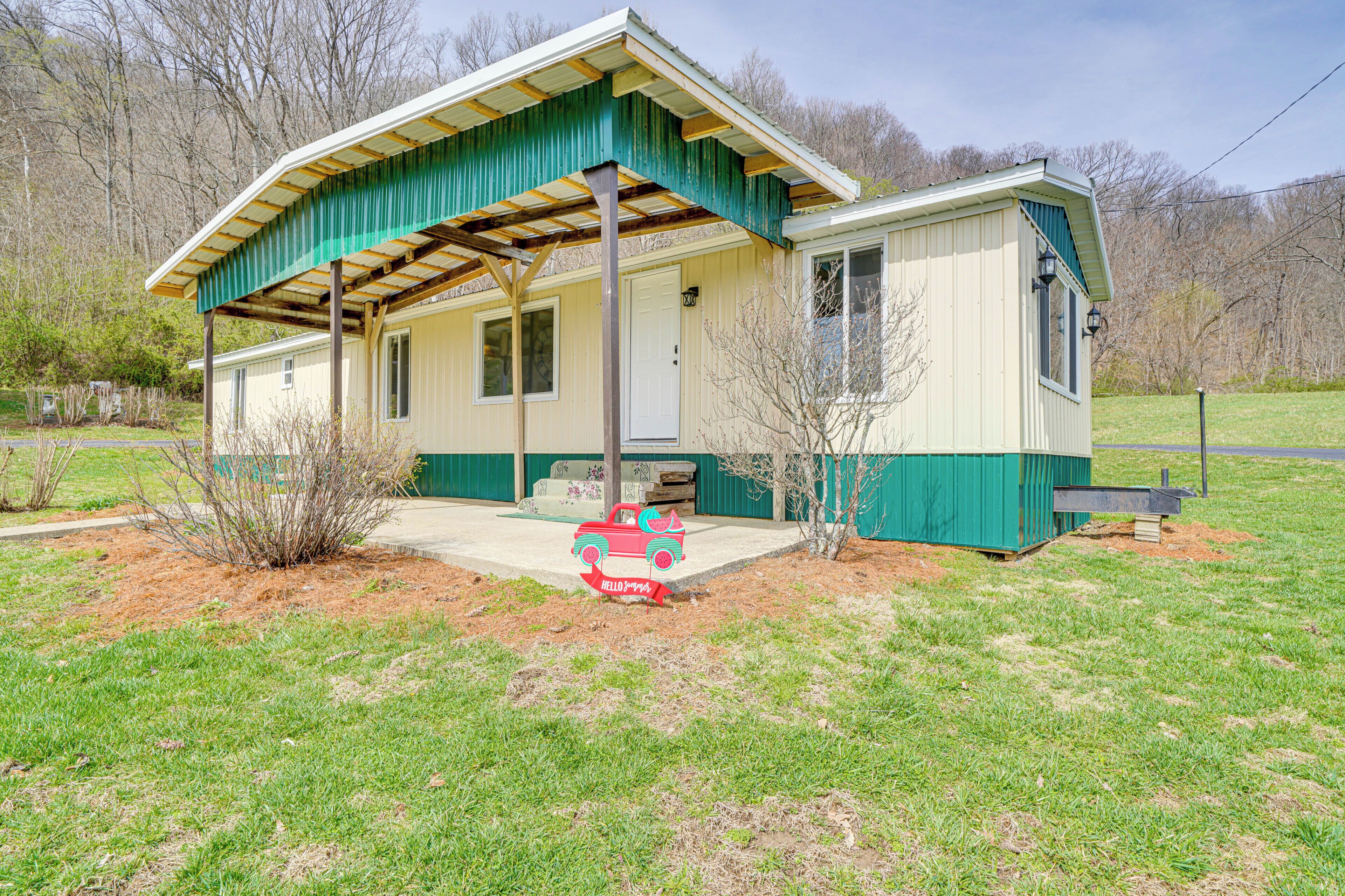 A single-story house with a green roof and a porch.