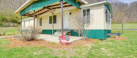 A single-story house with a green roof and a porch.