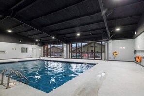 An indoor swimming pool with clear glass walls, a concrete floor, and a dark ceiling. - 205 Close to downtown, Landing and Convention Center (Branson)