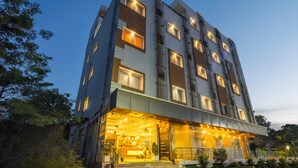 A multi-story hotel with illuminated windows and a well-lit entrance. - W Hotel Shamshabad Hyderabad Airport (Hyderabad)