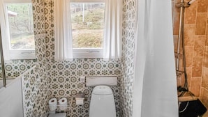 A compact bathroom with a toilet, bidet, and shower. - 4 Star Holiday Home in Stromstad (Stromstad)