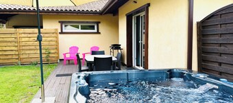 Wellness cottage in the woods. Close to sandy beaches. Private terrace with jacuzzi.