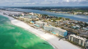 A coastal resort with beachfront hotels, a marina, and a road leading to the beach. - 🌊Islander 307 - Once Upon A Tide | Gulf Views-Pool-Beach Service🌊 (Fort Walton Beach)