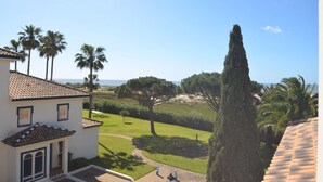 A coastal property with a white building, a tall cypress tree, and a view of the sea. - San Bruno 73 - Two Bedroom Apartment, Sleeps 5 (Punta del moral)