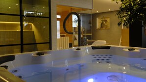 A modern spa area with a hot tub, glass walls, and a potted plant. - Relax in Wellness Room with Sauna and Spa Bath and luxurious outdoor seating. (Nieuwe Niedorp)