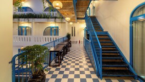 A checkered floor, blue railings, and a staircase. - The Linh Coastline Villa (Da Nang)
