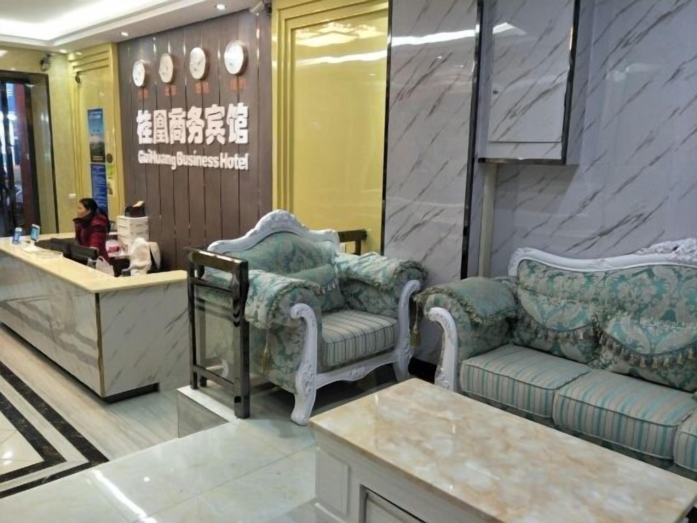 A reception area with a marble reception desk, a sofa, and a coffee table.