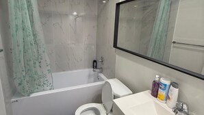 Une salle de bain avec une baignoire, des toilettes et un lavabo.
