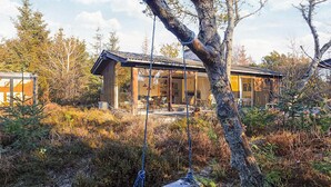 A modern house with a glass extension, surrounded by natural vegetation. - 4 Star Holiday Home in Albaek (Aalbaek)