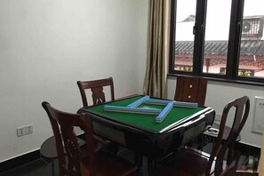 A room with a pool table, four wooden chairs, and a window with a view of traditional architecture. - Chang'an Hotel (Zhujiajiao Ancient Town Branch, Qingpu, Shanghai) (Shanghai)