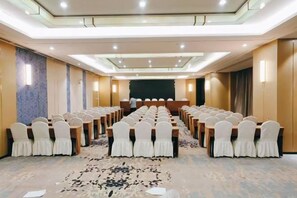 A conference room with rows of chairs, a podium, and a carpeted floor. - BaiLing Nicesoe Hotel (Guiyang Spray Pool Zilinan) (Guiyang)