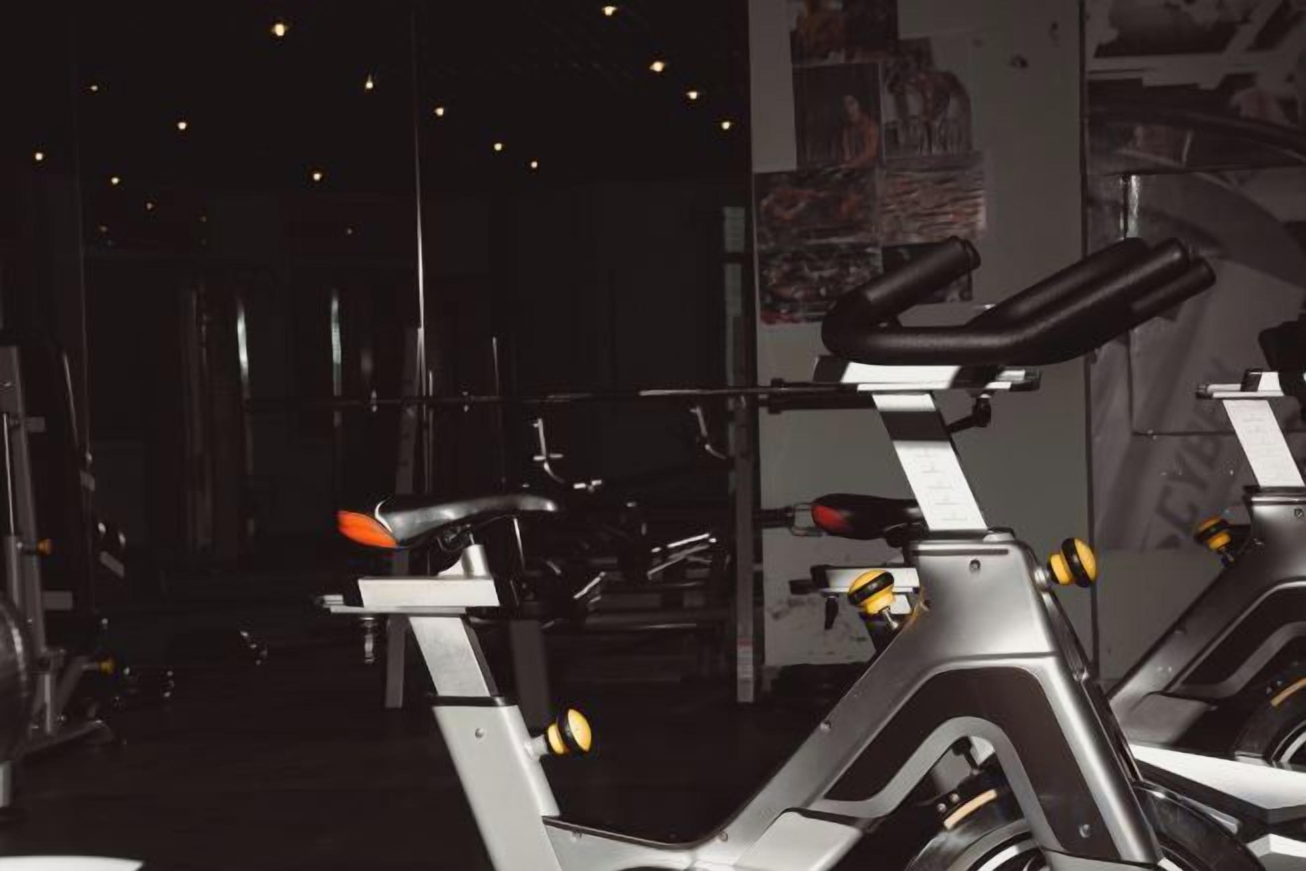 A gym with stationary bikes and weight machines.