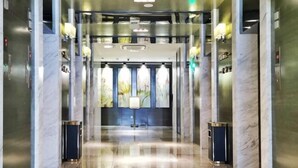 A modern elevator lobby with marble walls and a polished floor. - BaiLing Nicesoe Hotel (Guiyang Spray Pool Zilinan) (Guiyang)