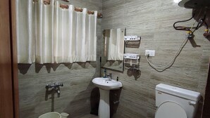A bathroom with a toilet, sink, and shower. - Lajawab Homestay  (Srinagar)