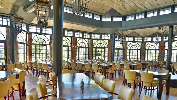 A spacious dining area with high ceilings, large windows, and traditional chandeliers. - 5 Star Holiday Home in Wangerland (Wangerland)