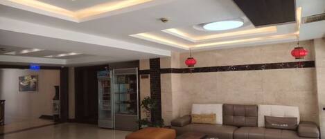 A modern living room with a sofa set, a coffee table, and a television.