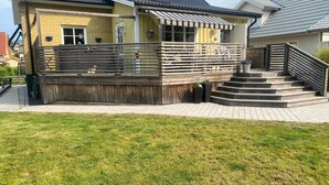A house with a wooden deck, a staircase, and a fenced yard. - 4 Star Holiday Home in Ronneby (Ronneby)