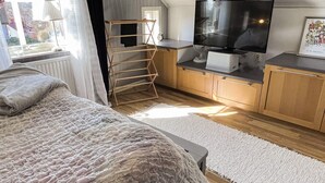 A bedroom with a bed, a wooden ladder, a TV, and a desk with a computer. - 4 Star Holiday Home in Ronneby (Ronneby)