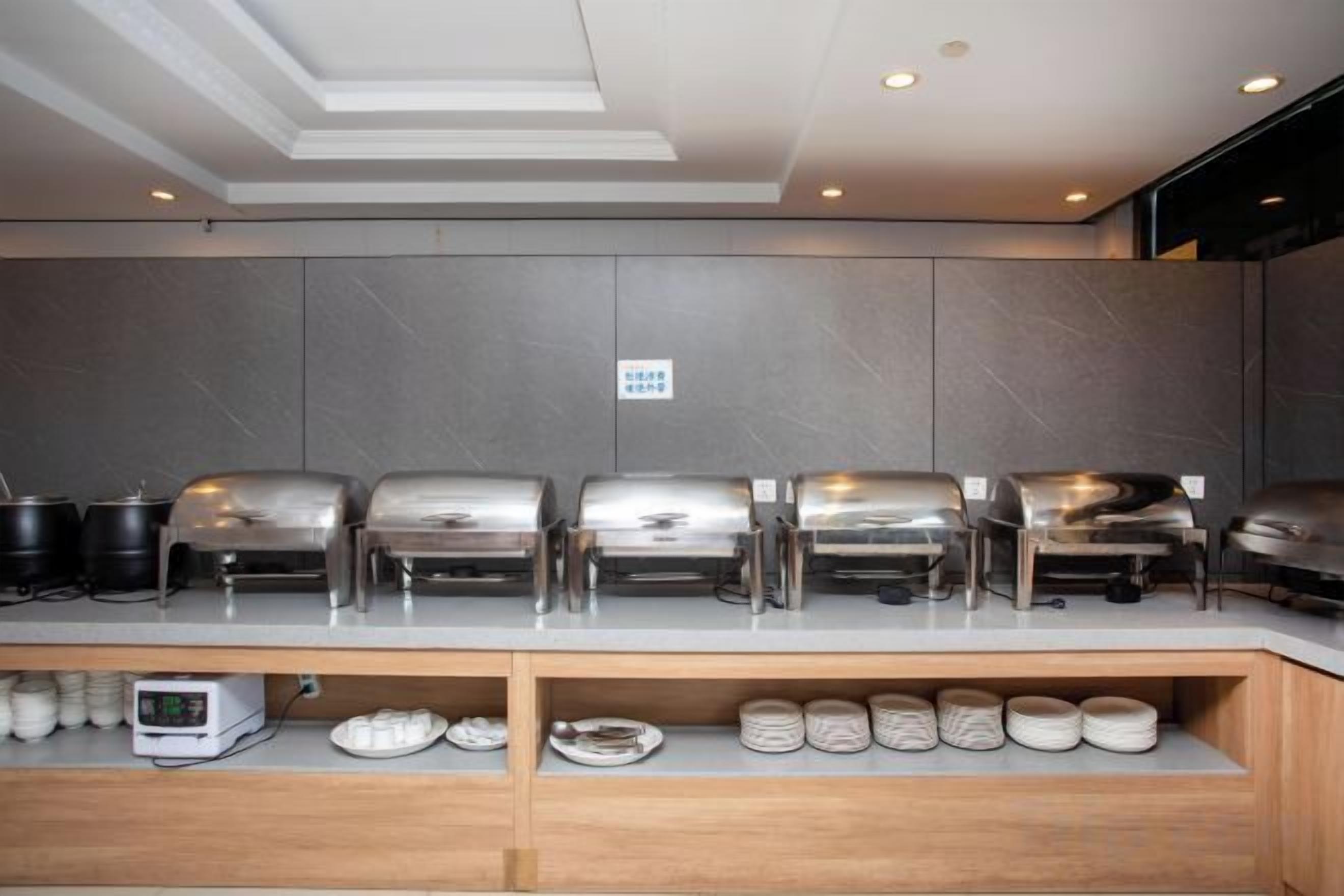 A buffet setup with multiple serving stations and a coffee machine.