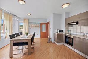 Apartment | Private kitchen | Highchair - Serene Seafront Apartment in Kampor (Rab)