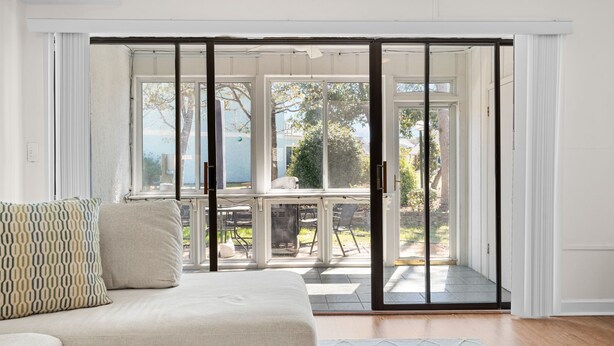 A room with a sliding glass door leading to an outdoor patio area.