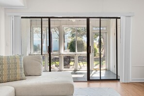 A room with a sliding glass door leading to an outdoor patio area. - 🏝️ Private 2BR Townhouse – 1 Mile to Beach + Golf Views! 🏌️‍♂️ Dogs stay free (North Myrtle beach)