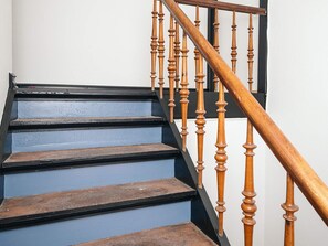 A staircase with wooden balusters and blue steps.
