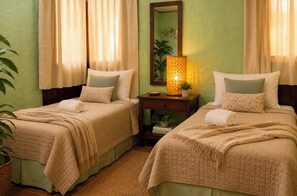 A hotel room with two beds, a nightstand, a lamp, a mirror, and a potted plant. - Volcano Viewing fromCasa Maya Lodge! (Masatepe)