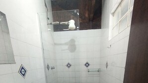 A small bathroom with a sink, toilet, and shower. - Comfort Suite 302 (Diamantina)