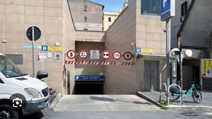 A parking garage entrance with multiple signs indicating parking restrictions and directions. - Paradise Vatican Home (Roma)