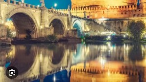 A historic building with a large central dome, a bridge with arches, and a body of water reflecting the structure. - Paradise Vatican Home (Roma)