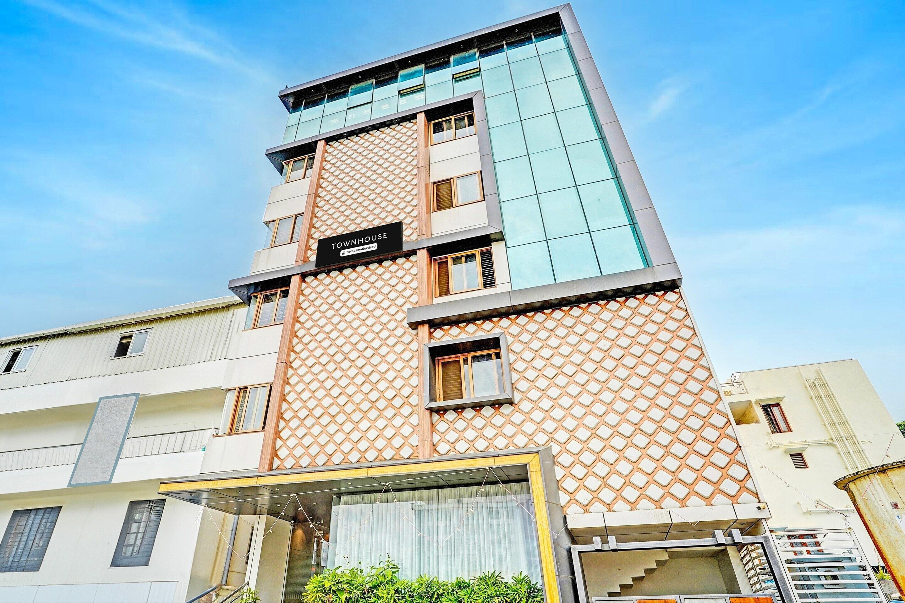 A multi-story hotel with a modern design, featuring a prominent 'Townhouse' sign on the facade.
