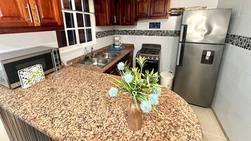 Fridge, stovetop, cookware/dishes/utensils, dining tables