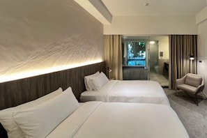 A hotel room with two beds, a chair, a desk, and a view of the outdoors. - Crownshine Resort (Yilan)