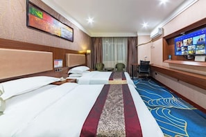 A hotel room with two beds, a television, and a desk with a computer. - Lanzhou Huayu Business Hotel (Lanzhou)