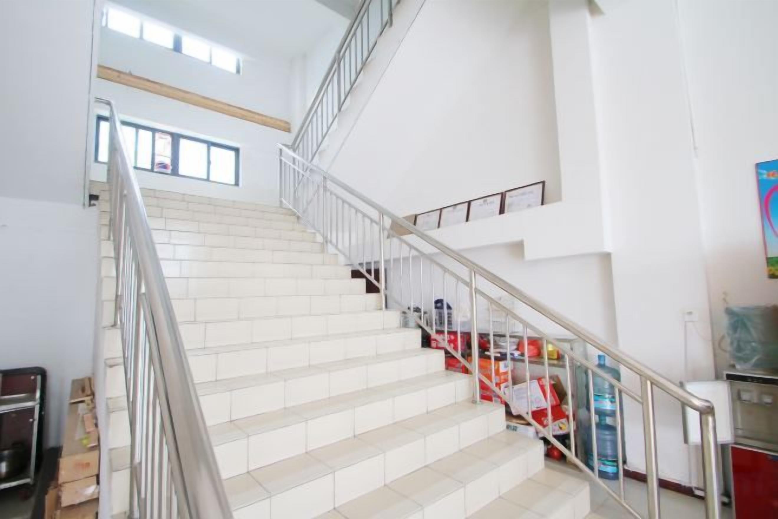 A staircase with metal railings, leading to an upper floor.