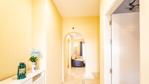 A hallway with a white door, a white console table, and a potted plant. - Holiday Home 'Vista Hermosa' with Lake View, Wi-Fi and Air Conditioning (Ayamonte)