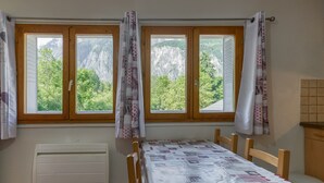 Een kamer met een bed, een radiator en een raam met gordijnen.