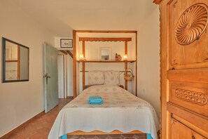 A bedroom with a bed, a wooden wardrobe, a mirror, and a door. - Holiday Home 'Saint Vincent De Mercuze Casavilla' with Mountain View, Private Pool and Wi-Fi (Saint-Vincent-de-Mercuze)