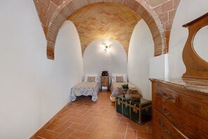 A room with two beds, a dresser, a chest of drawers, and a brick ceiling. - Holiday Home 'Toscana' with Shared Pool, Private Garden and Wi-Fi (Colle di Val d'Elsa)